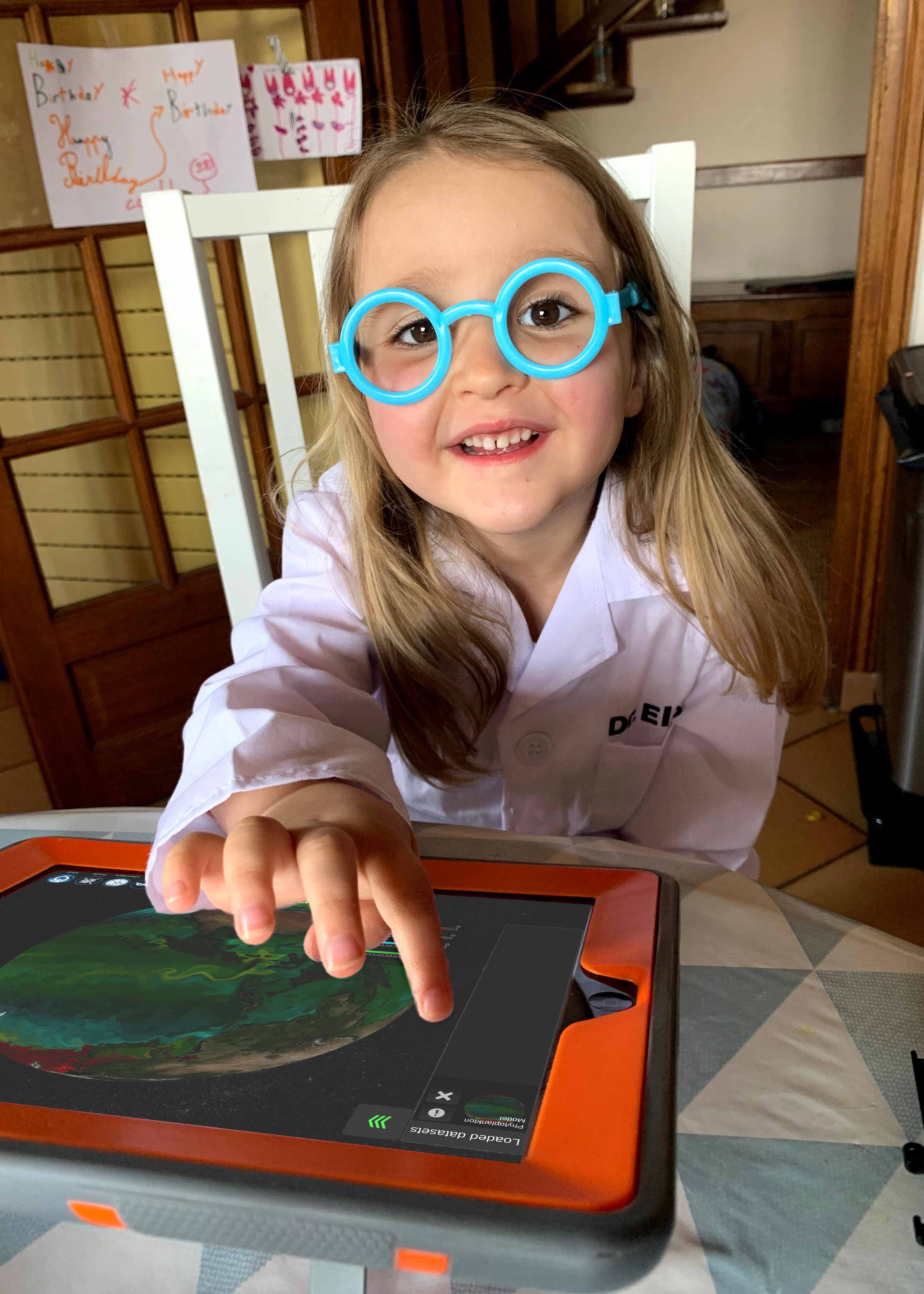 A young scientist plays with SOS Explorer mobile app.